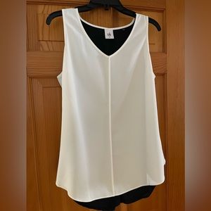 Cabi Sleeveless V neck white top with black mesh back. Beautiful design.